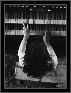 Overhead shot of Kate at the piano - from the book Cathy, by her brother Jay